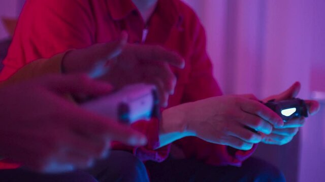 Excited friends father and son playing online video games on modern console next gen 2020, new era of consoles, white gamepad, man group at home play games