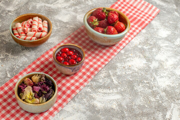 front view candies and jelly with strawberries on white background candy sweet flower