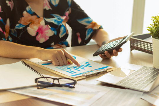 financial adminstrator use pen analyzing calculate in business