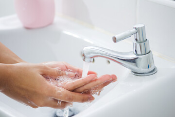 Hygiene concept. Washing hands with soap under the faucet with water