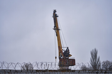 an old crane works in the port