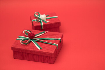 Red gift box for christmas theme on the red background.