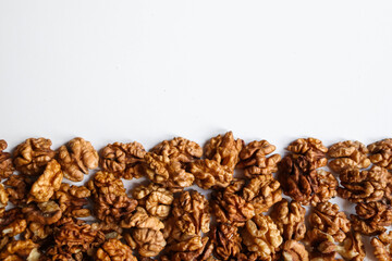 Top view of peeled walnuts placed on a white