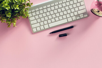 Modern pink office desk table  with  smartphone and other supplies eye glasses and cup of coffee,.for input the text in the middle. Top view, flat lay.