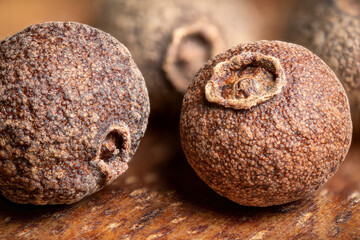 super macro shot of allspice dry pepper in detail very close. food spice background