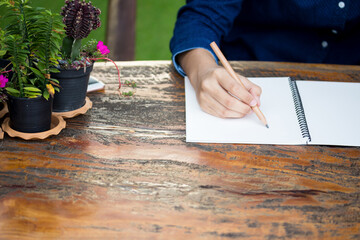 Close-up Of Businessperson Signing Contract,Man writing paper at the desk with pen and reading books