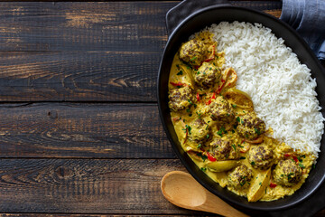 Meatballs with rice, curry sauce, lime and red pepper. Healthy eating.