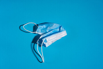 Blue face mask on blue background. Medicine and healthcare.