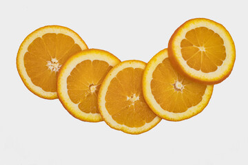 Raw fresh orange slices organized in pattern group, isolated on white background
