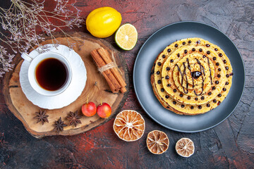 top view yummy sweet pancakes with cup of tea on dark background cake milk sweet dessert
