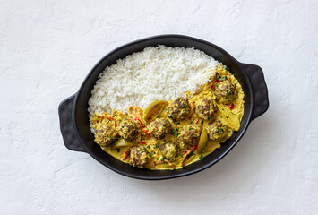 Meatballs with rice, curry sauce, lime and red pepper. Healthy eating.