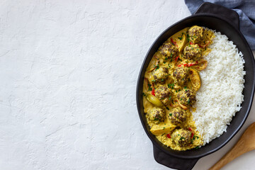 Meatballs with rice, curry sauce, lime and red pepper. Healthy eating.