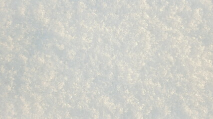 White snow winter texture. Christmas holiday background. Seasonal fresh white  nature snow. Snowflakes close-up on the snow.