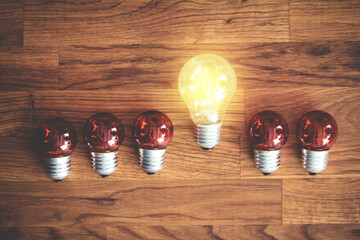 White light bulb glowing separate from others