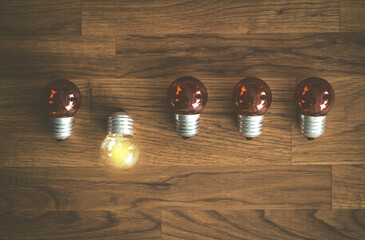 White light bulb glowing separate from others