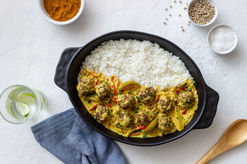 Meatballs with rice, curry sauce, lime and red pepper. Healthy eating.