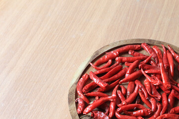 Dried chili on a wooden tray and copy space.