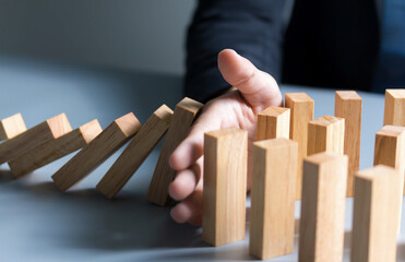 Chain Reaction In Business Concept, Businessman Letting Or Preventing Dominoes Continuous Toppling...