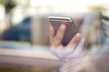 use digital mobile on side view in cafe shop