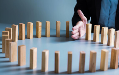 leadership  Planning, risk and strategy in business, businessman gambling placing wooden block on a tower