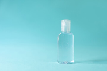 Transparent alcohol bottle is a device to prevent and stop the corona virus. on blue isolated backgroun