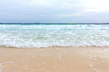 Fototapeta na wymiar Blue ocean wave on sandy beach summer day