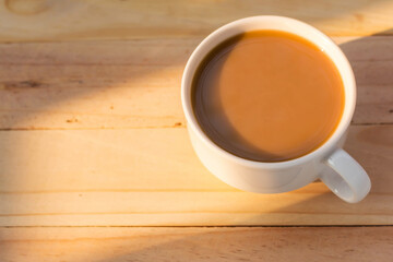 Coffee cup on wood table with filter effect worm tone
