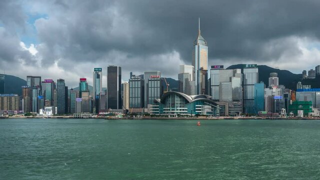 Daytime time lapse view of Victoria Harbour and famous Hong Kong skyline. Hong Kong is a major financial hub in Asia and one the world's most modern cities.