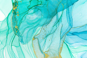 Alcohol ink blue and gold abstract stains on white background. Drops watercolor transparent texture.