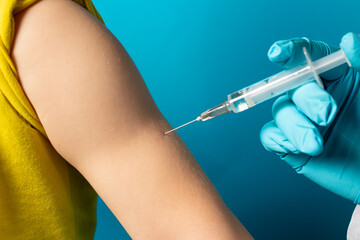 The doctor or nurse injects the child in the arm' in the shoulder. The concept of vaccination in...