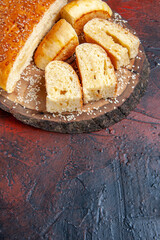 front view delicious sweet pastry sliced in pieces on the dark background dough cake pie