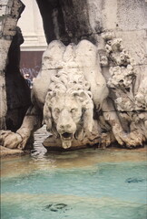 Fototapeta na wymiar View of The lion statue of the Fountain of the Four Rivers at Piazza Navona in Rome, Italy.