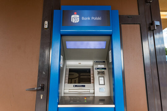 Serock, Poland - July 08, 2020: Blue ATM Of PKO BP Bank. Taking Cash Out Of An ATM. Self-service For Banking Operations.