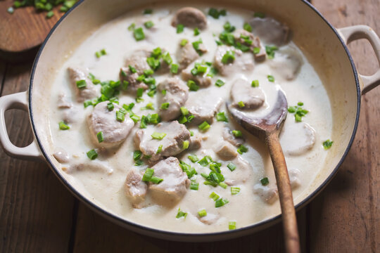 Pork tenderloin pieces in horseradish sauce with chives and mashed potatoes 