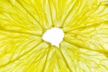 Close-up of a yellow lemon slice isolated on a white background.