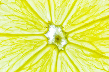 Close-up of a yellow lemon slice isolated on a white background.
