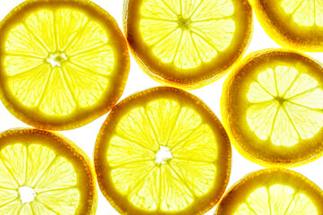 Yellow lemon slices isolated on a white background.