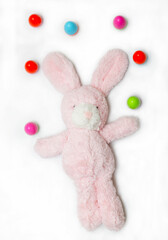 Easter pink bunny with colorful eggs on a white background. For wallpaper, postcards and backgrounds.