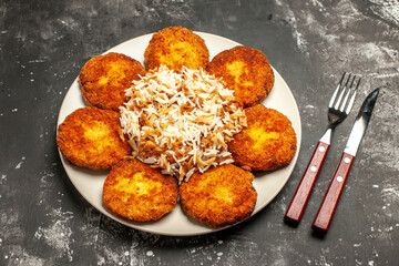 top view tasty fried cutlets with cooked rice on the dark background dish meal photo meat