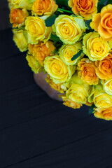 bouquet of yellow roses and pumpkin on black wooden board. Beautiful yellow roses. Autumn decor