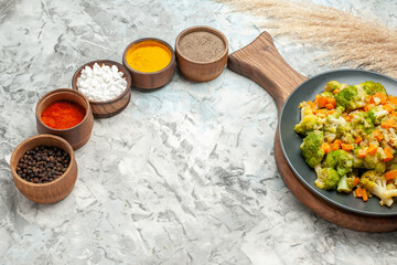 Top view of healthy vegetable salad different spices on white background