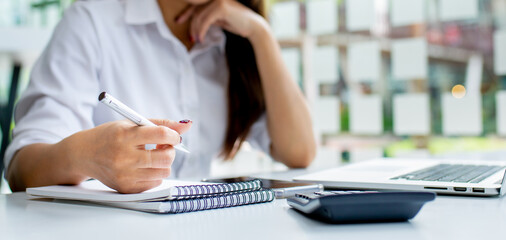 Financial Businesswomen analyze the graph of the company's performance to create profits and...