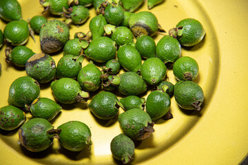 Fresh green guava fruits on yellow background