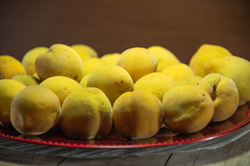 Ripe fresh peach fruits on wooden background
