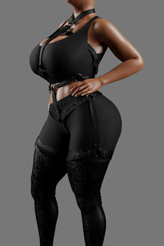 Sensual woman in black latex costume and leather straps