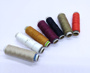 Old vintage hand sewing machine Colored thread coils or bobbin on white background, sewing machine accessories. selective focus. image