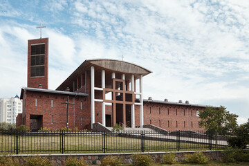 Fototapeta na wymiar GRODNO, BELARUS - AUGUST 2015: Most Holy Redeemer Catholic church or Red Church of redemptorists in Grodno Hrodna Belarus unusual architectural form built in the neo-constructivist architecture style.