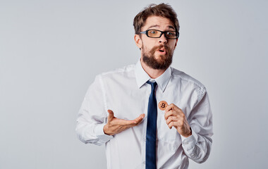 Man in shirt and tie with coin in hand success joy cryptocurrency Bitcoin exchange rates