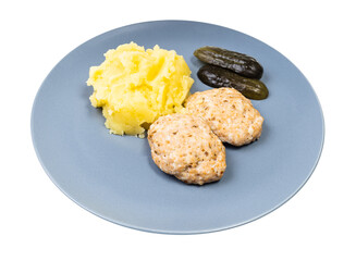 portion of homemade steamed red fish cutlets and mashed potatoes on blue plate isolated on white background