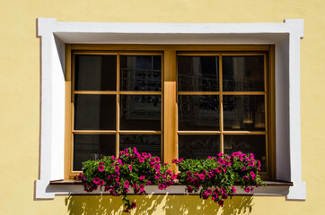 Fototapeta na wymiar Traditional ornamented window in Selva village, Gardena valley, Dolomites, South Tirol, Italy.